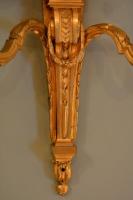 A pair of French neo-classical two light candle sconces.