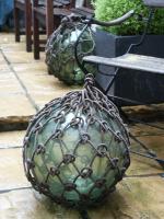 One of a number of early-20th century, glass & rope, fishing floats