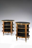 A Pair of Open Library Bookcases Inset with Oval Black Leather Tops