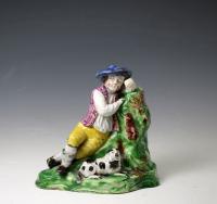 Antique Staffordshire pottery figure of a shepherd boy and his dog, early 19th century