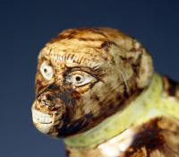 Early Staffordshire “Wood family”figure of a monkey decorated in underglaze colours