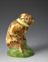 Early Staffordshire “Wood family”figure of a monkey decorated in underglaze colours