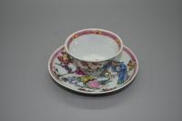 Depicting figures in a garden scene, decorated with overglaze polychrome enamels.  China  Yongzheng/Qianlong Reign: 18th century  Cup: H: 3.5cm D: 6.3cm   Saucer: 10.3cm D