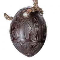 Coconut shell “bugbear” powder flask with a plaited braid carrying strap