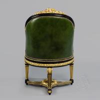A Louis XVI Style Gilt and Ebonised Carved Rotating Desk Chair Upholstered in Green Leather