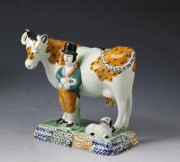 Pair of antique Yorkshire pottery prattware cows with attendants, Mexborough Pottery