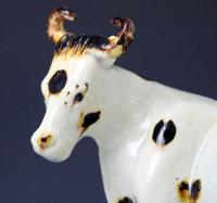 Yorkshire pottery figure of a cow with calf early 19th century England