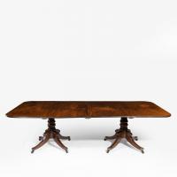 George III pair of mahogany console tables which convert into a twin pillar dining table
