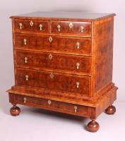 A fine and rare walnut oyster-piece chest-on-stand