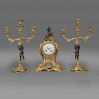 A Fine Louis XV Style Gilt and Patinated Bronze Figural Clock Garniture by Maison Baguès. French, Circa 1870.