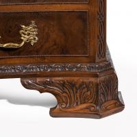 An unusual pair of early 20th century walnut serpentine commodes