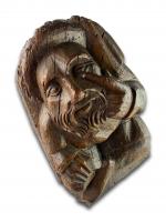 Corbel of a seated man in fashionable clothing. Northern France, 15th century