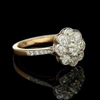 A classic old European brilliant cut diamond cluster ring set in platinum and 18ct rose gold