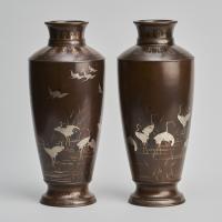 A pair of stylish Meiji Period Japanese bronze vases with crane decoration