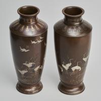 A pair of stylish Meiji Period Japanese bronze vases with crane decoration
