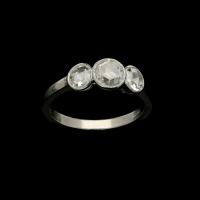 A pretty three stone diamond ring set with 1.21cts of rose cut diamonds in milegrained platinum