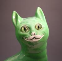 Staffordshire pottery figure of a green comical cat in the Galle manner c1900