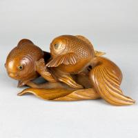 An amusing wood Okimono of a pair of long-tailed gold fish