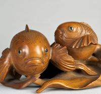 An amusing wood Okimono of a pair of long-tailed gold fish