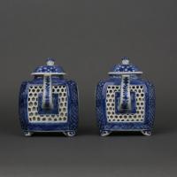 A pair of Chinese porcelain blue and white reticulated square form teapots and covers, Early Qianlong, circa 1740