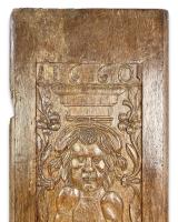 A large oak relief of a grotesque figure. French, dated 1660