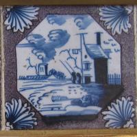 A set of four 18th century, English manganese delftware tiles in a gilt frame