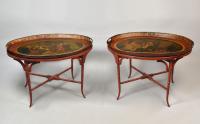 A near pair of Pontypool or Wolverhampton red ground oval trays on later painted stands, c.1790