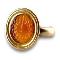 Gold ring set with a Roman intaglio depicting the sword of Zeus & a Laurel wreath