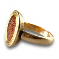 Gold ring set with a Roman intaglio depicting the sword of Zeus & a Laurel wreath