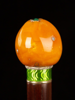 A fine Fabergé cane handle, of rare butterscotch amber, modelled as a small fruit, with inset diamond stones