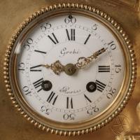 detail of the clock face from A Louis XVI Style Figural Mantel Clock, By Grohé Frères