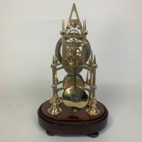 Brass skeleton clock in glass dome | BADA