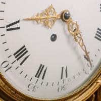A Detail of A Large Louis XVI Style Carved Giltwood Clock and Barometer Set Dating From Circa 1860