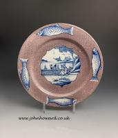 Large English delftware pottery plate manganese ground with four fish in the border. Circa 1750