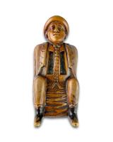 Fruitwood snuff box carved as a coachman relieving himself. Dutch, circa 1780
