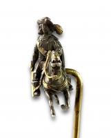 Silver & gold stick pin of a 17th century man on a horse. French, 19th century