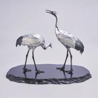 Japanese pair of silvered bronze cranes signed in an oval reserve Hidenao Meiji period
