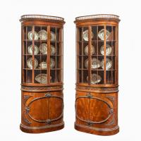 A pair of mahogany shaped display cabinets attributed to Gillows