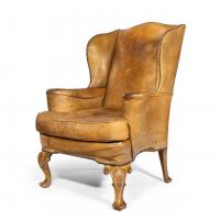 A pair of walnut wing armchairs in the Queen Anne style