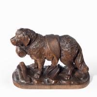 A Black Forest carved linden wood model of a mount rescue dog
