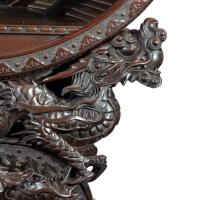 A Meiji period carved hardwood circular display cabinet