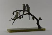 An Austrian cold painted bronze group of 3 Budgerigars perched on branches