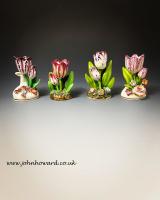 A collection of four Staffordshire models of tulips standing amongst flowers and leaves. circa 1825