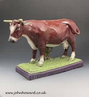 Large scale pottery pearlware figure of a cow standing on a base Staffordshire England early 19th century