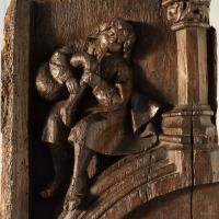 A rare mid-15th century carved oak panel of a musician, English, circa 1450