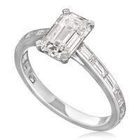 A 1.52ct emerald-cut diamond and platinum solitaire ring with baguette diamond set band	