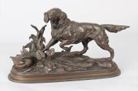A fine bronze sculpture of a gun dog with a duck resting
