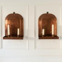 An attractive pair of sheet copper and engraved twin-light wall sconces, English or Scottish, circa 1905