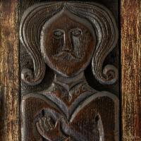 three 17th century carved oak figural terms in a frame