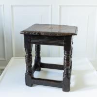 An early 17th century low oak stool
